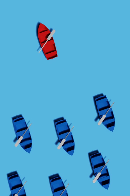 A group of boats floating on top of a blue ocean