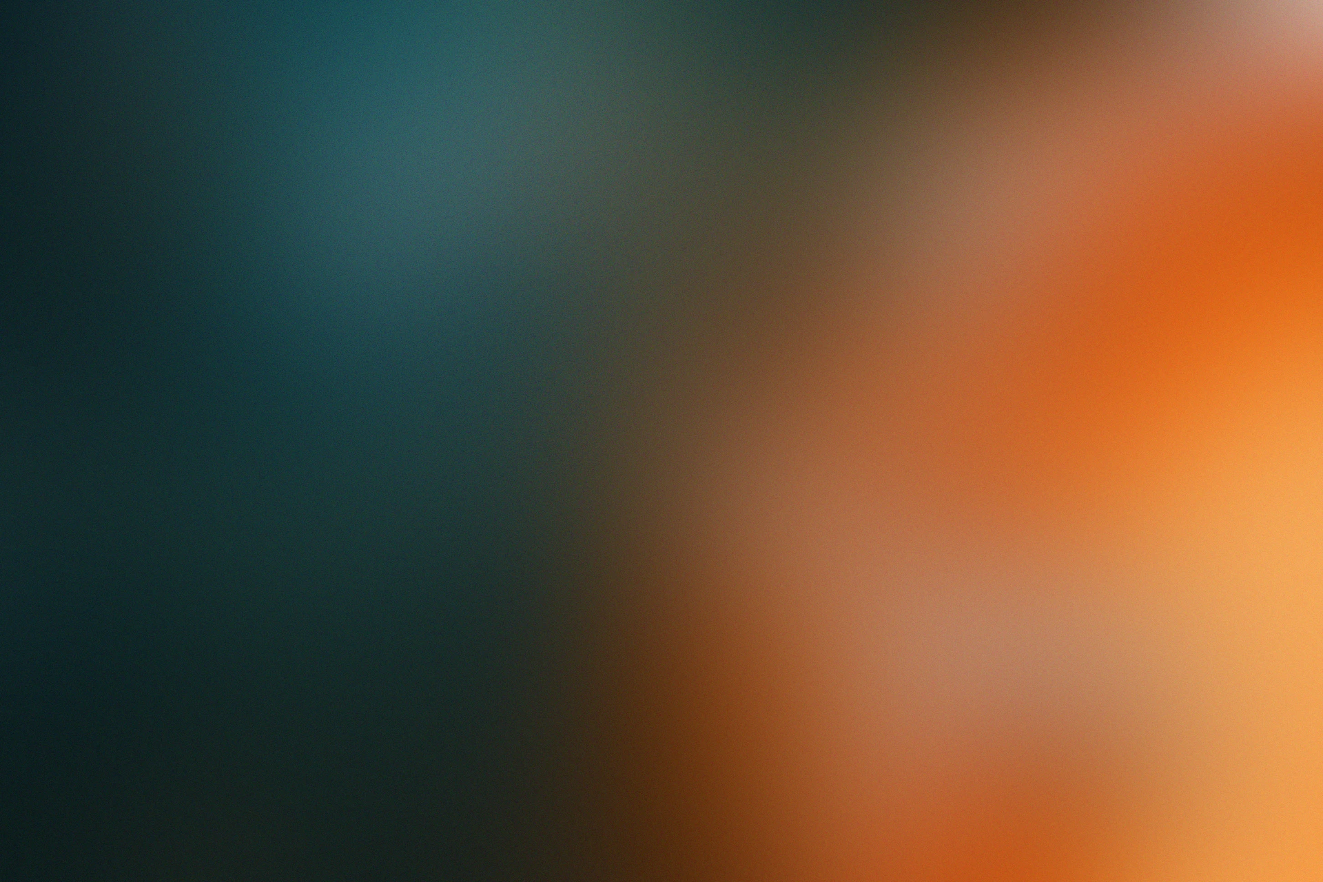 A blurry image of an orange and blue background