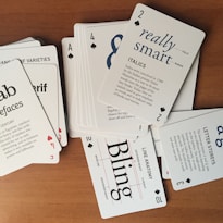 A pile of playing cards sitting on top of a wooden table