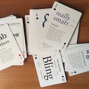 A pile of playing cards sitting on top of a wooden table
