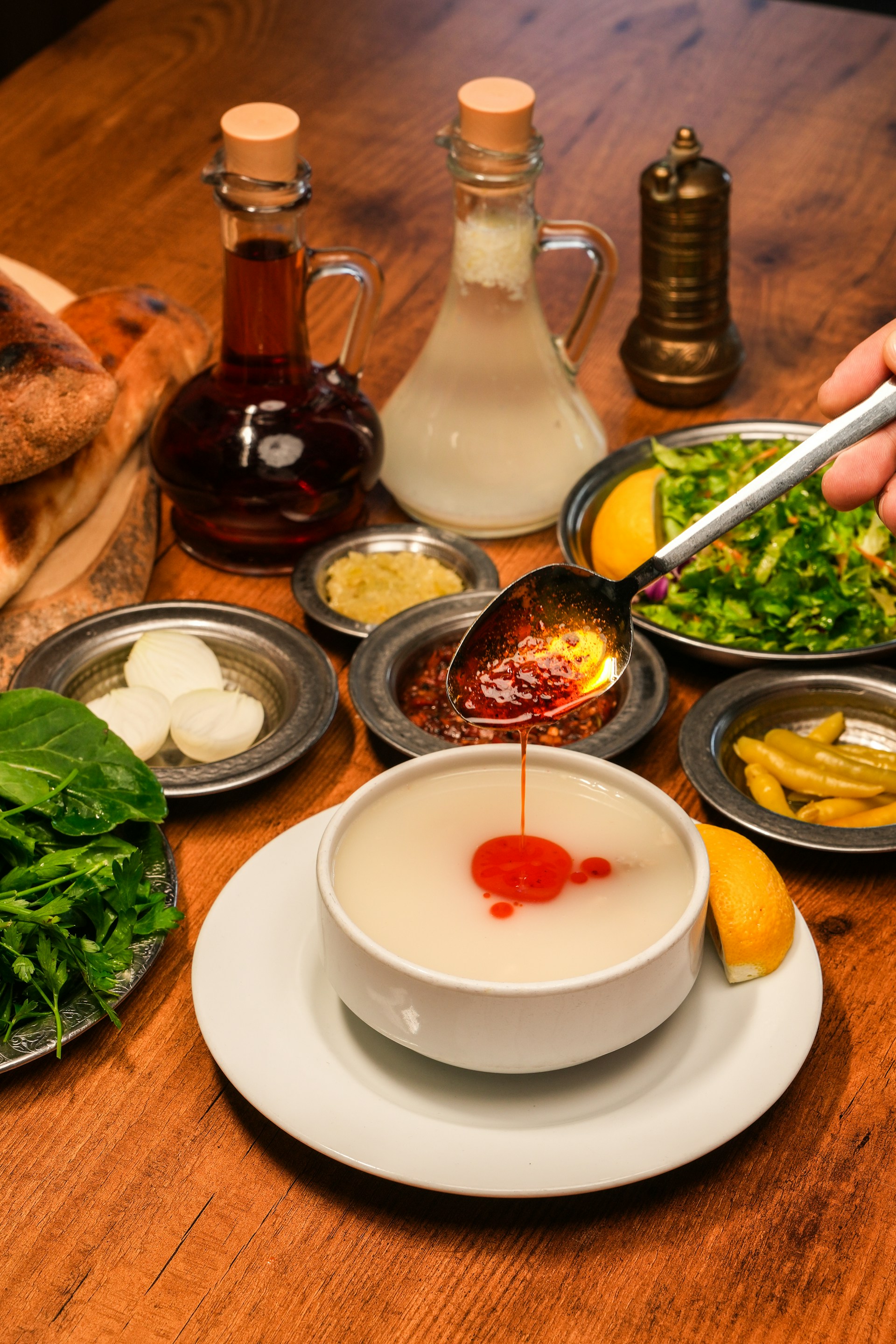 A wooden table topped with plates and bowls filled with food