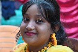 A woman in a yellow dress sitting in a chair