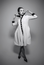 A woman in a white dress posing for a picture
