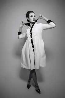 A woman in a white dress posing for a picture