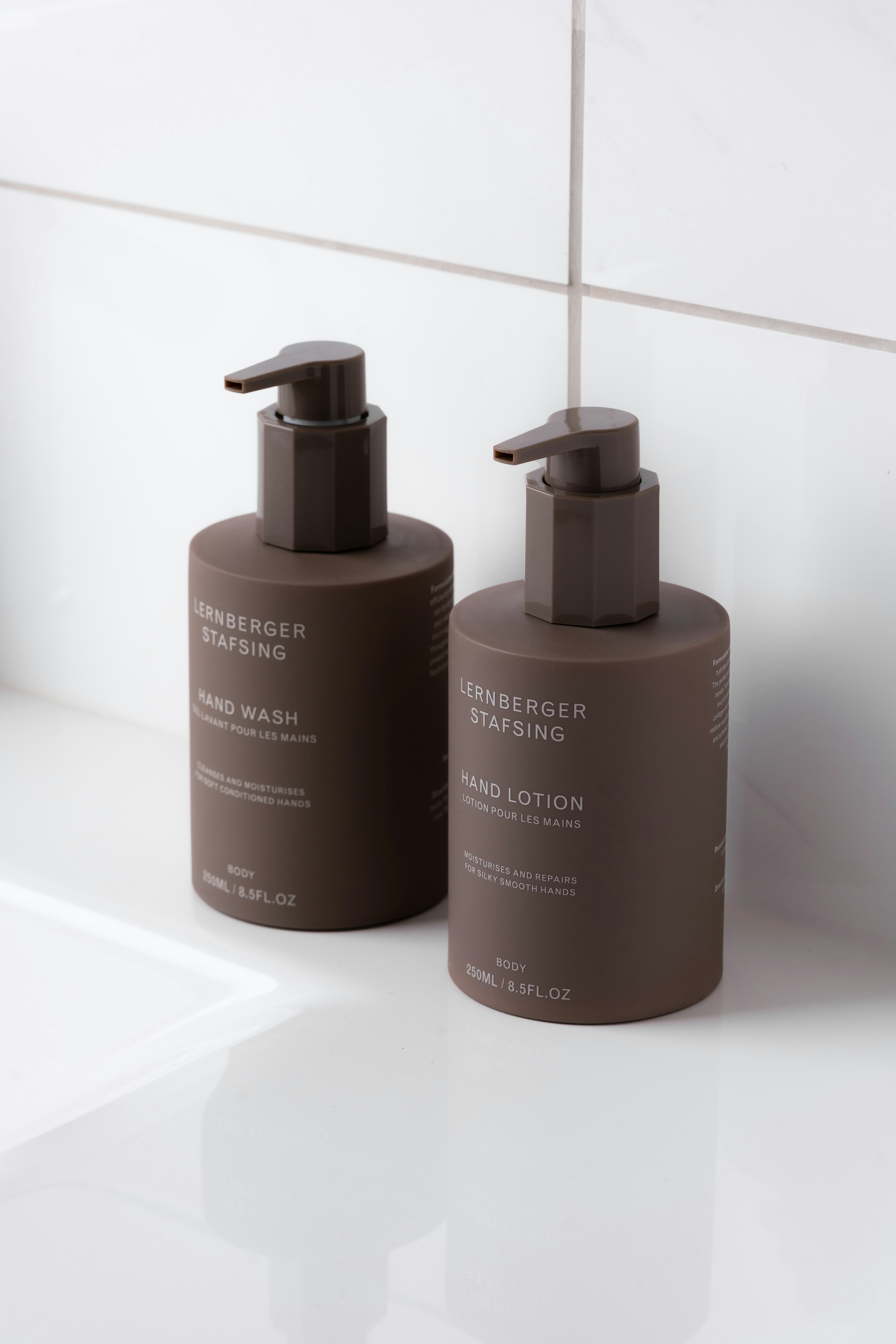 A couple of brown bottles sitting on top of a white counter