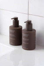 A couple of brown bottles sitting on top of a white counter