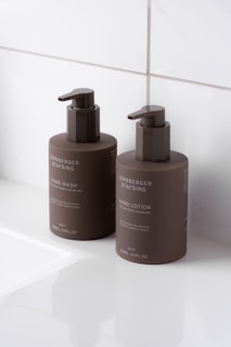 A couple of brown bottles sitting on top of a white counter