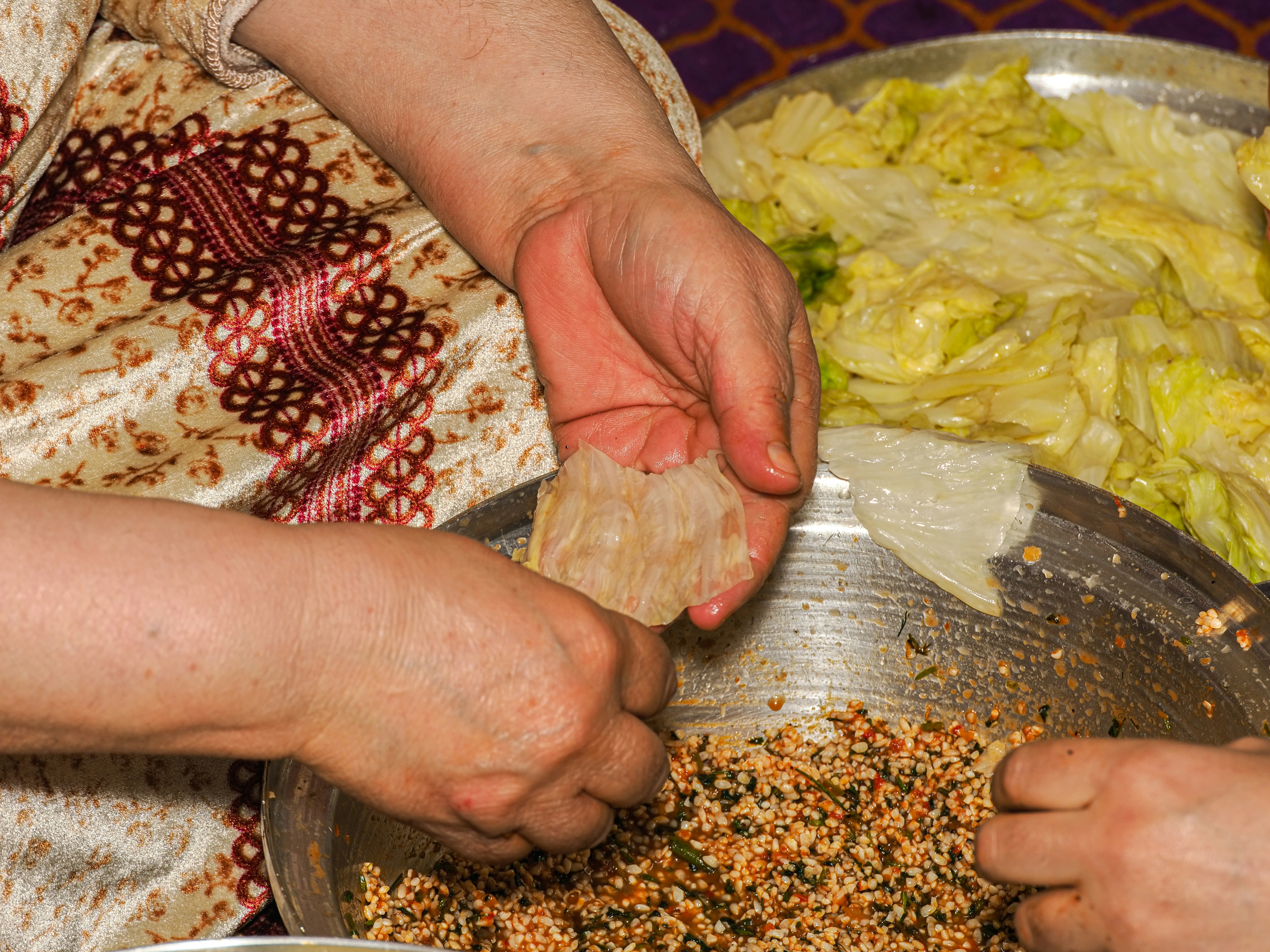 A group of people that are standing in front of a bowl of food
