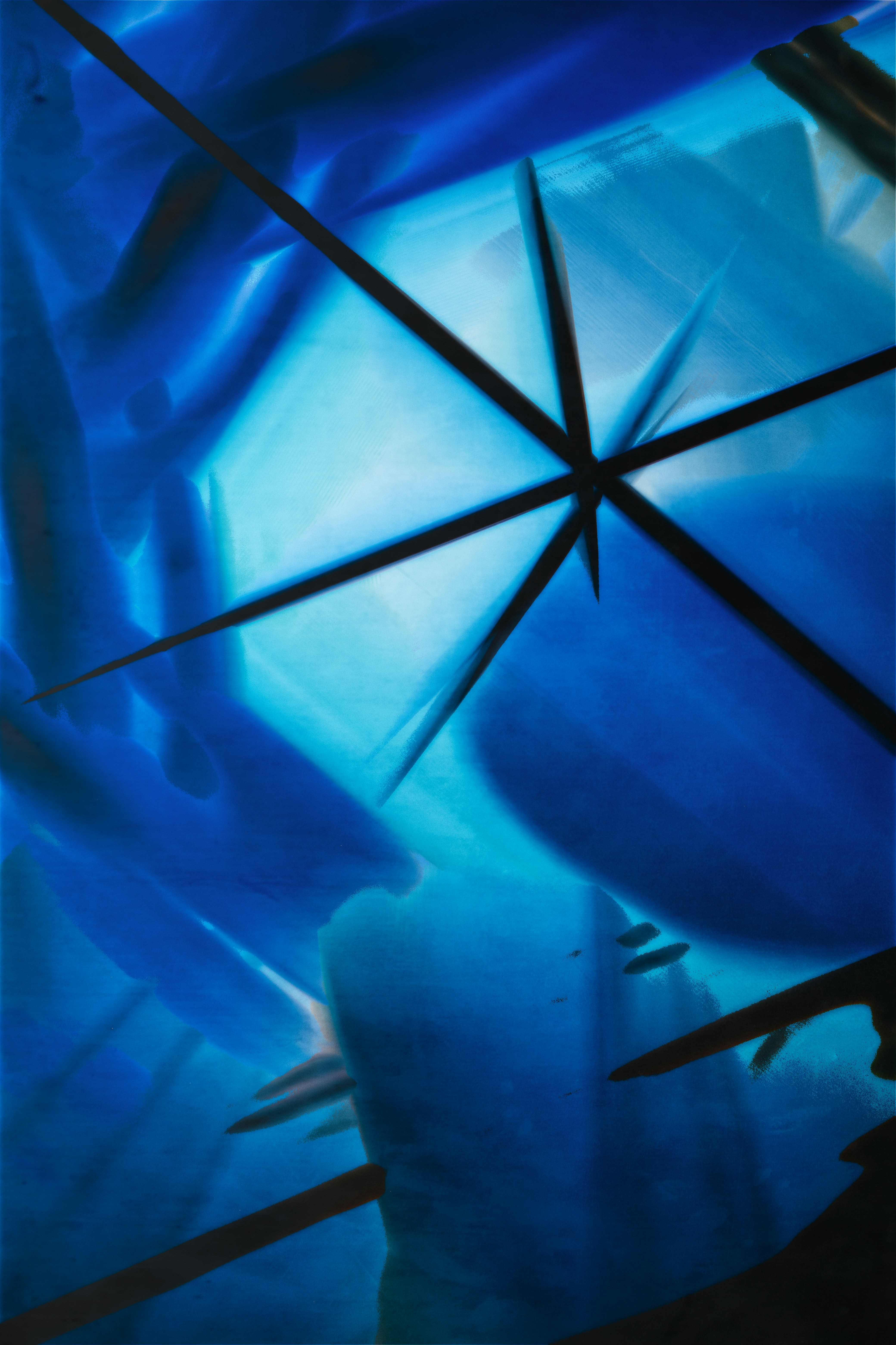 A close up of a blue umbrella with black lines