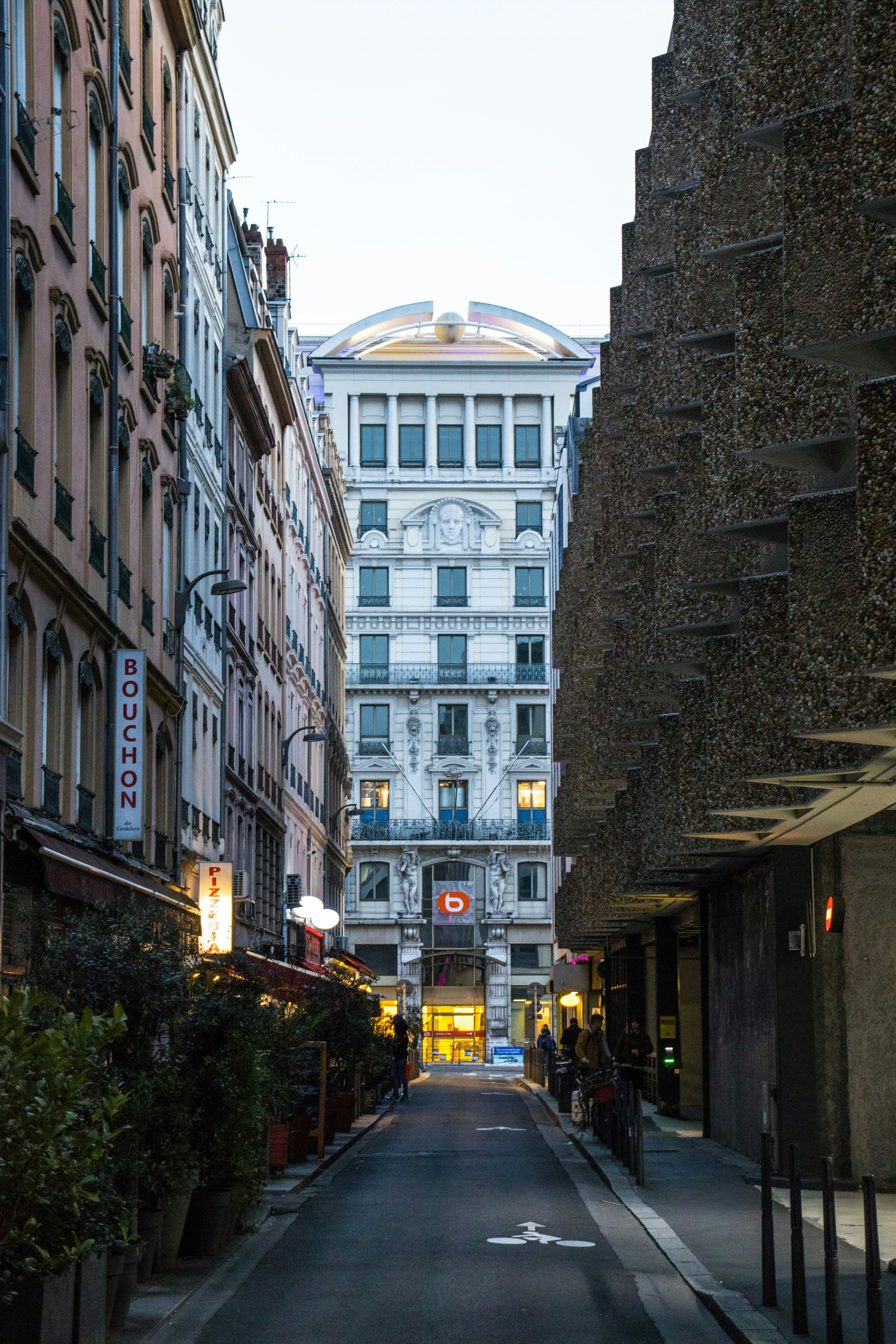 a narrow city street lined with tall buildings