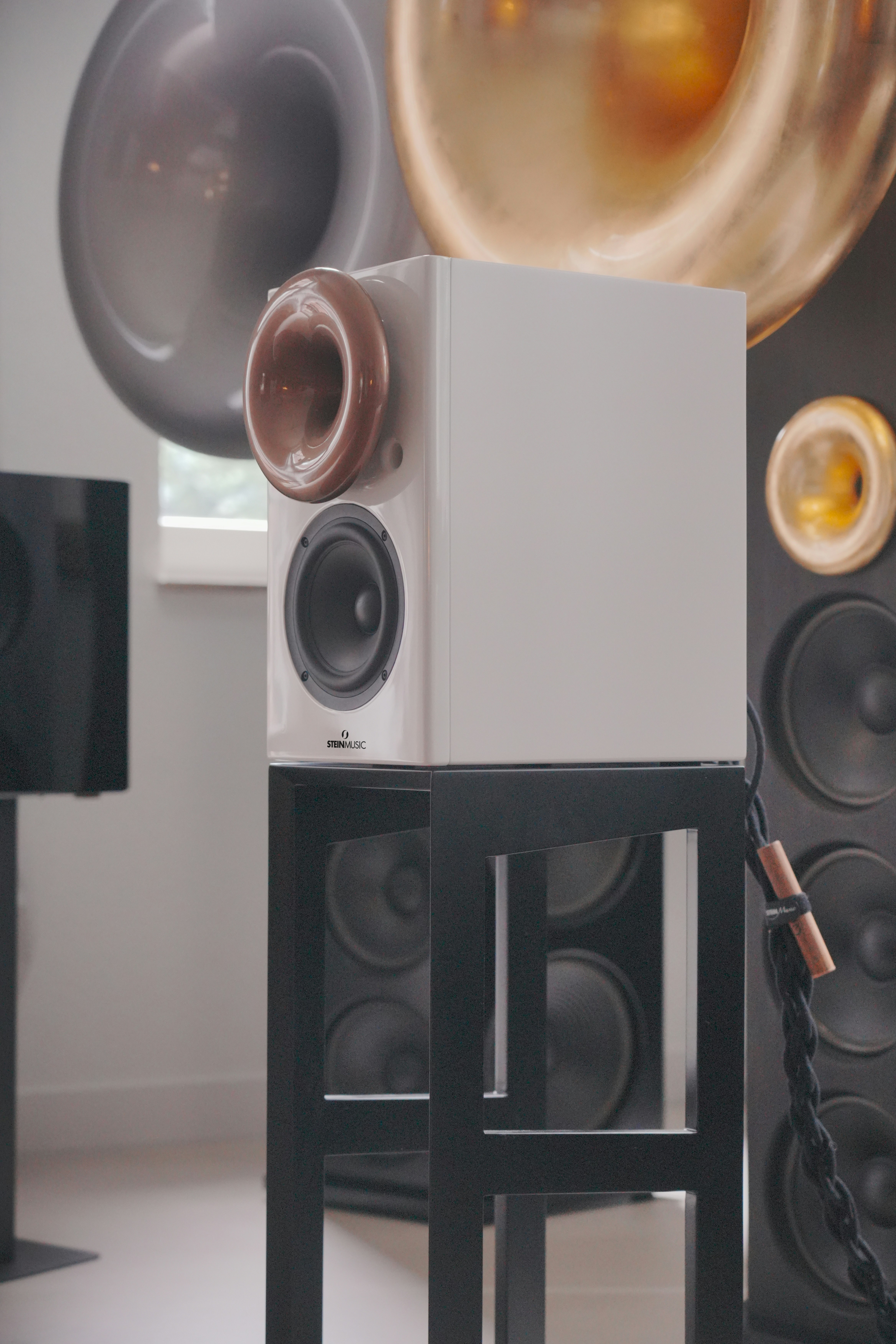 A white speaker sitting on top of a black table