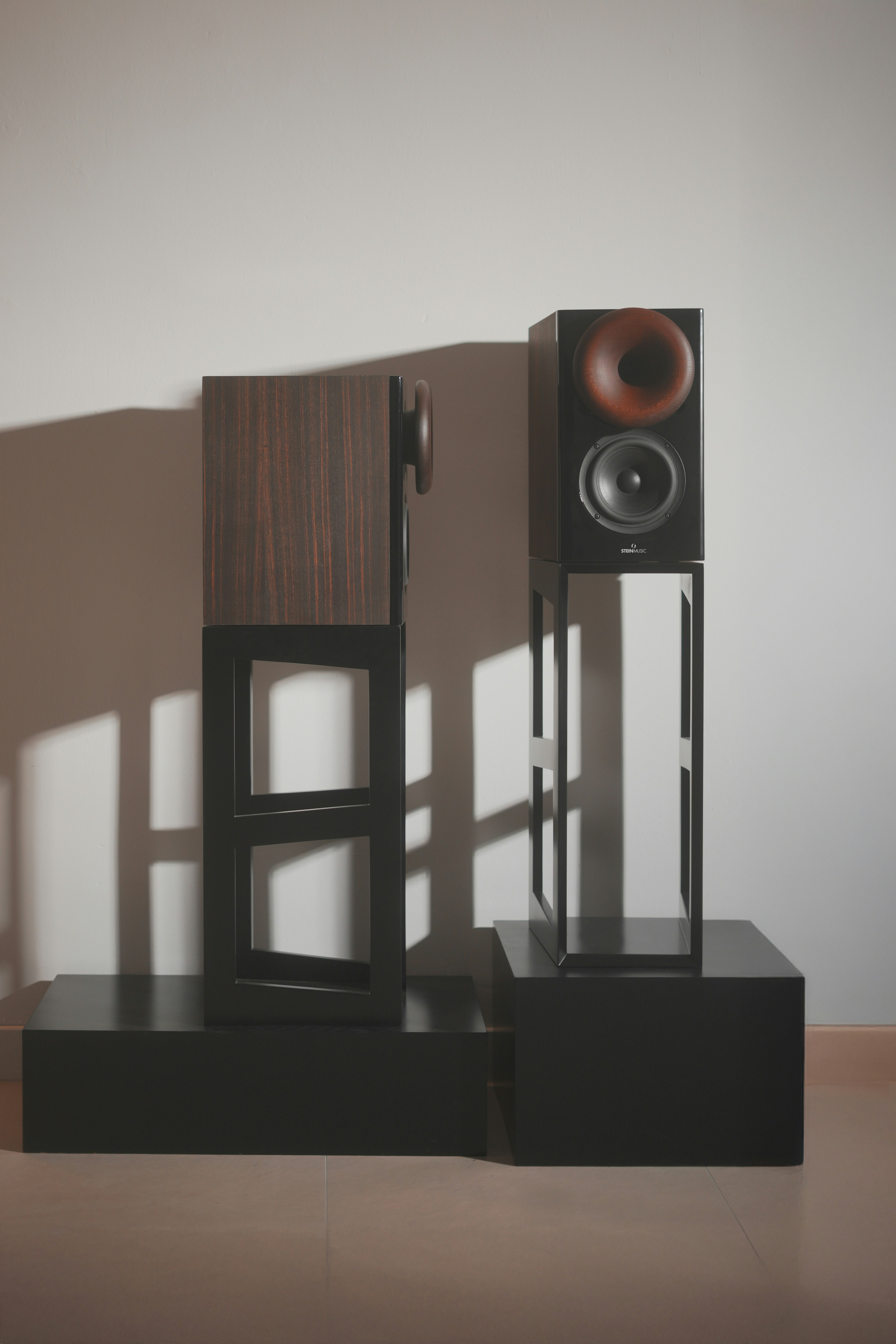 A couple of speakers sitting on top of a wooden table