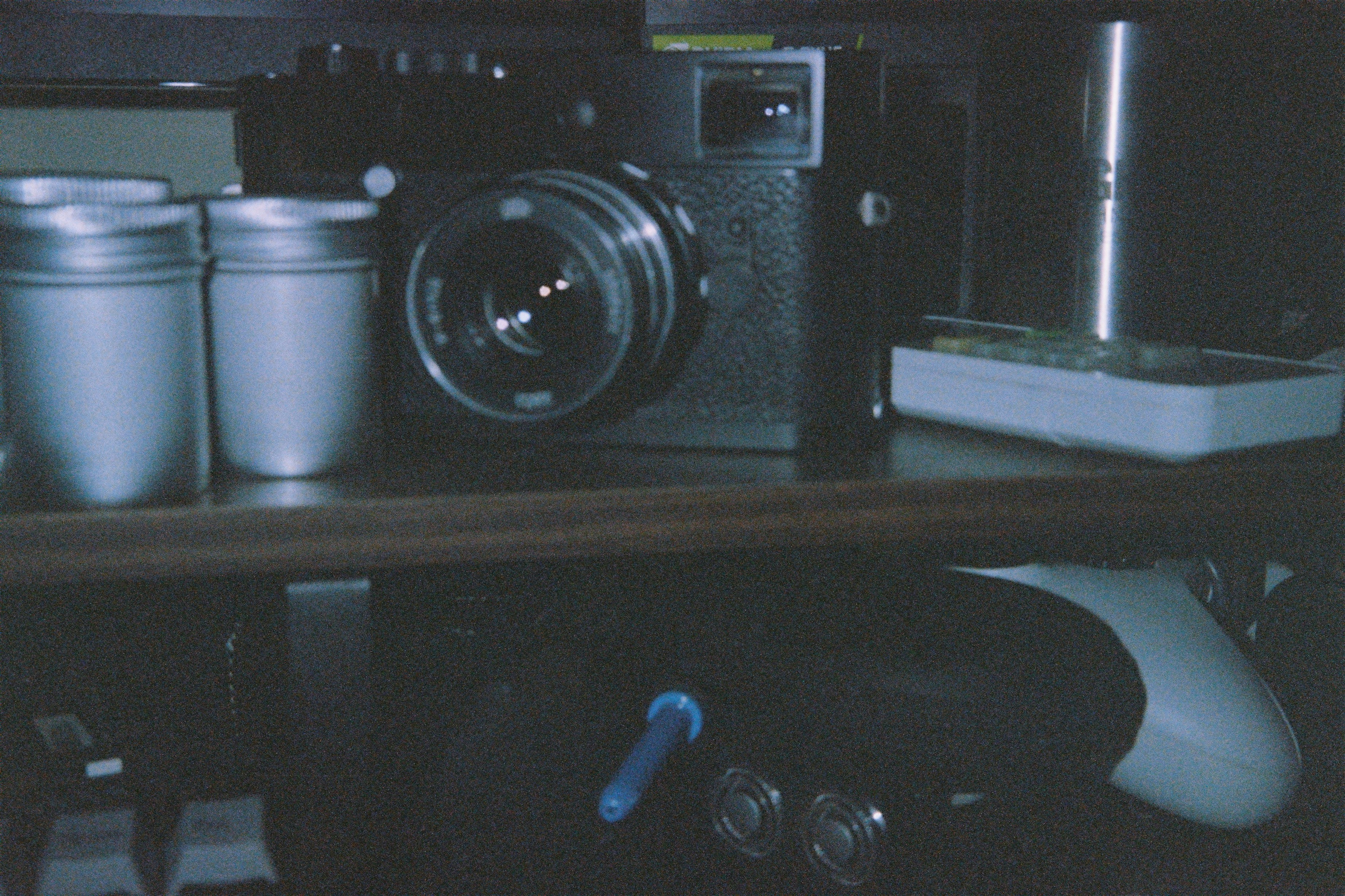 A camera sitting on top of a wooden shelf