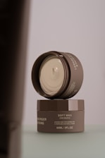 A jar of cream sitting on top of a table