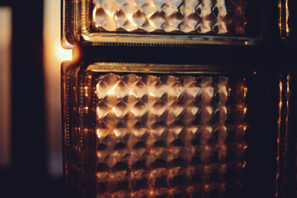 Close-up view of a warm brown glass vase with diamond pattern on its surface