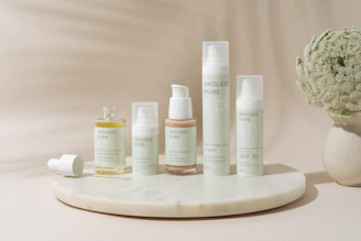 A white vase filled with lots of different types of skin care products