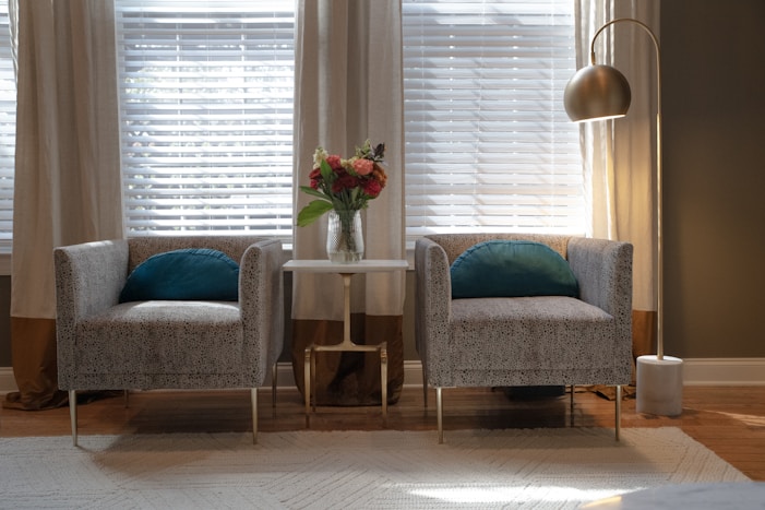 A living room with two chairs and a table