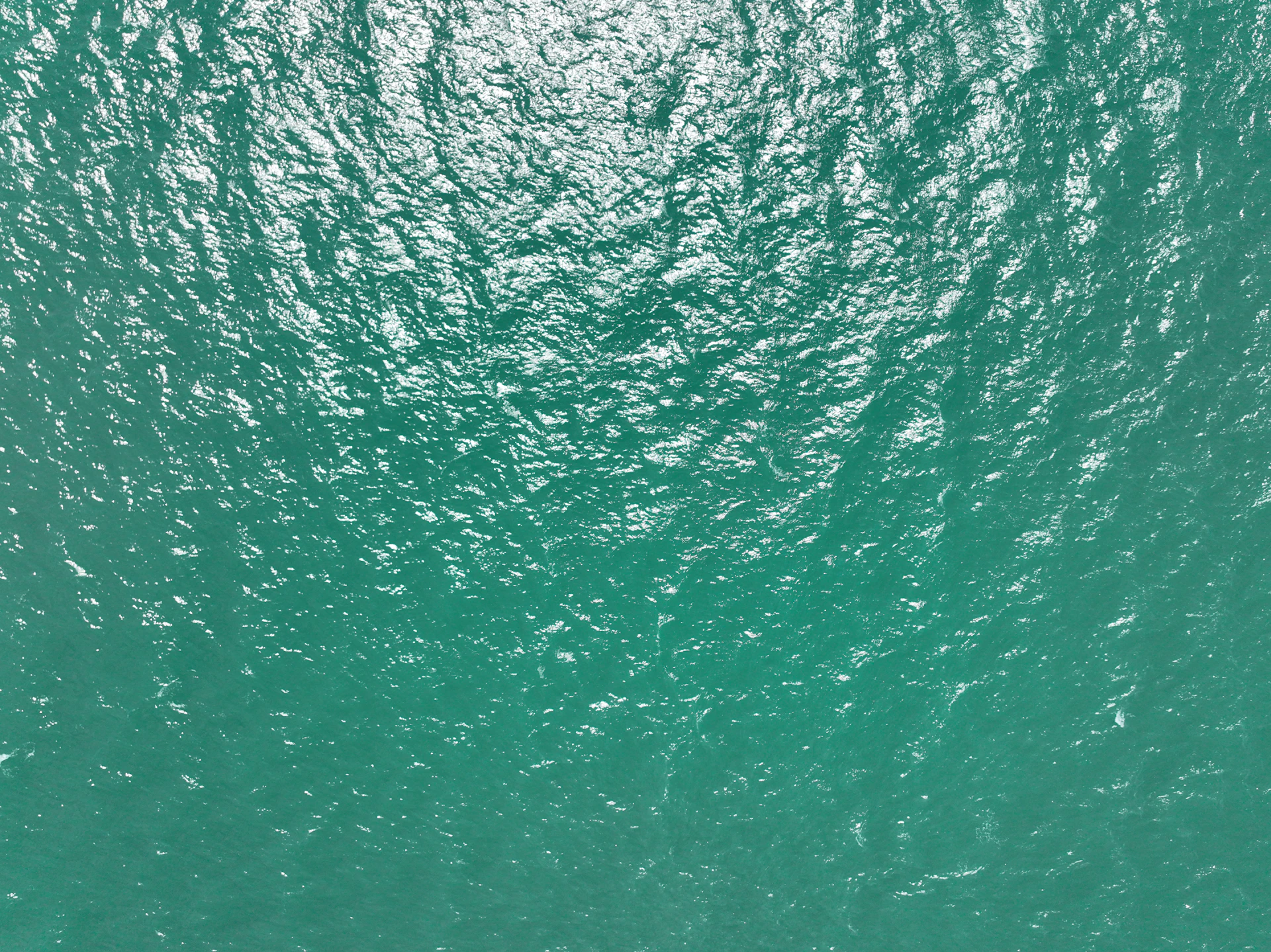 An aerial view of a boat in a body of water