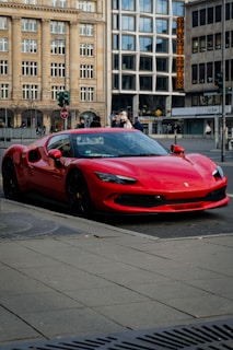 A red sports car parked on the side of the road