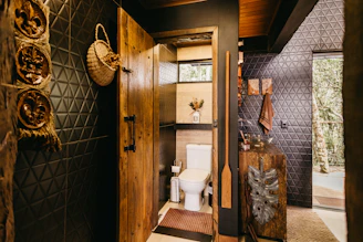 A bathroom with a toilet and a wooden door
