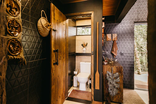 A bathroom with a toilet and a wooden door