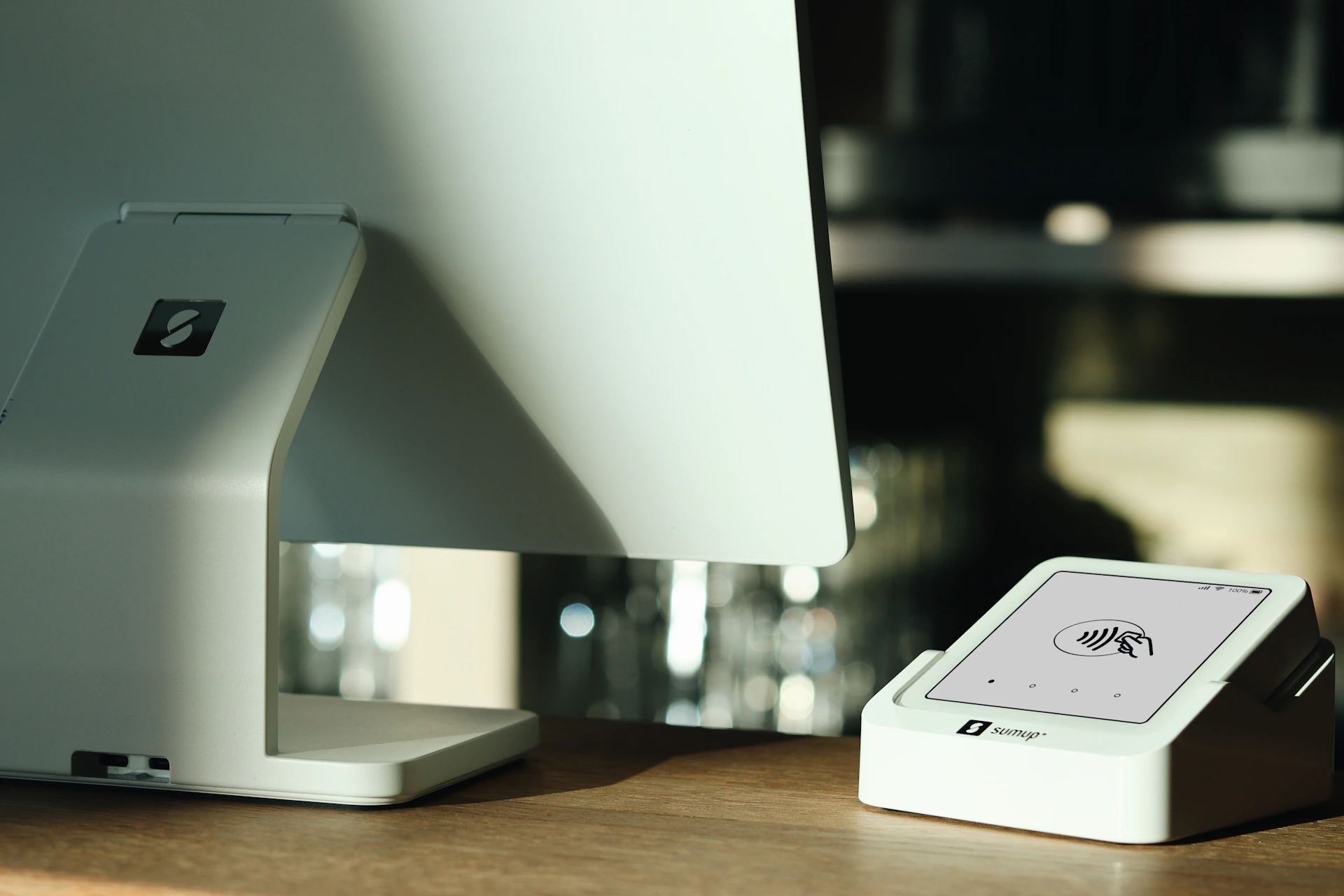 A computer monitor sitting on top of a wooden desk