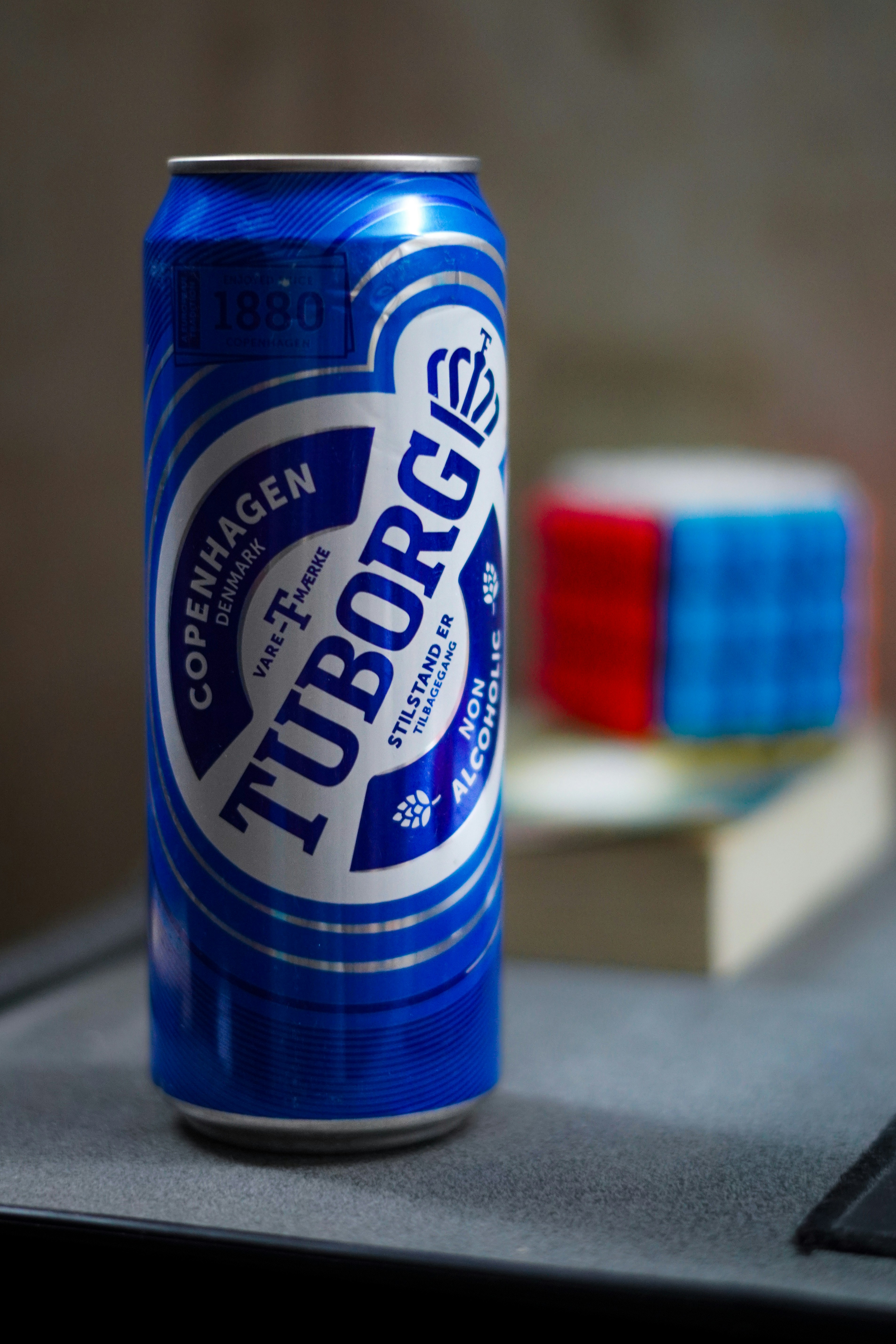 A can of beer sitting on top of a laptop