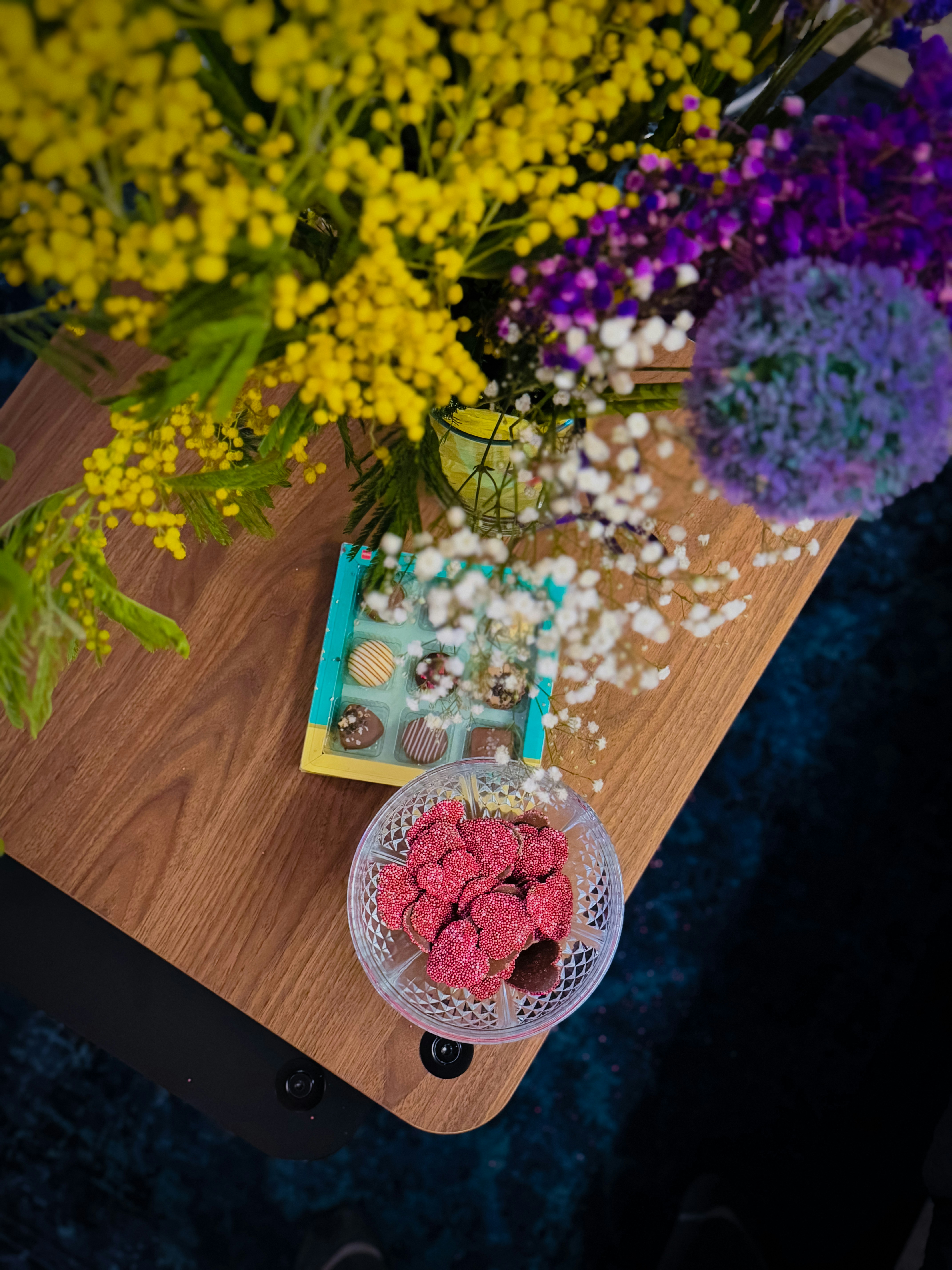 A wooden table topped with a bowl of food