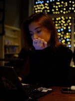 A woman sitting in front of a laptop computer
