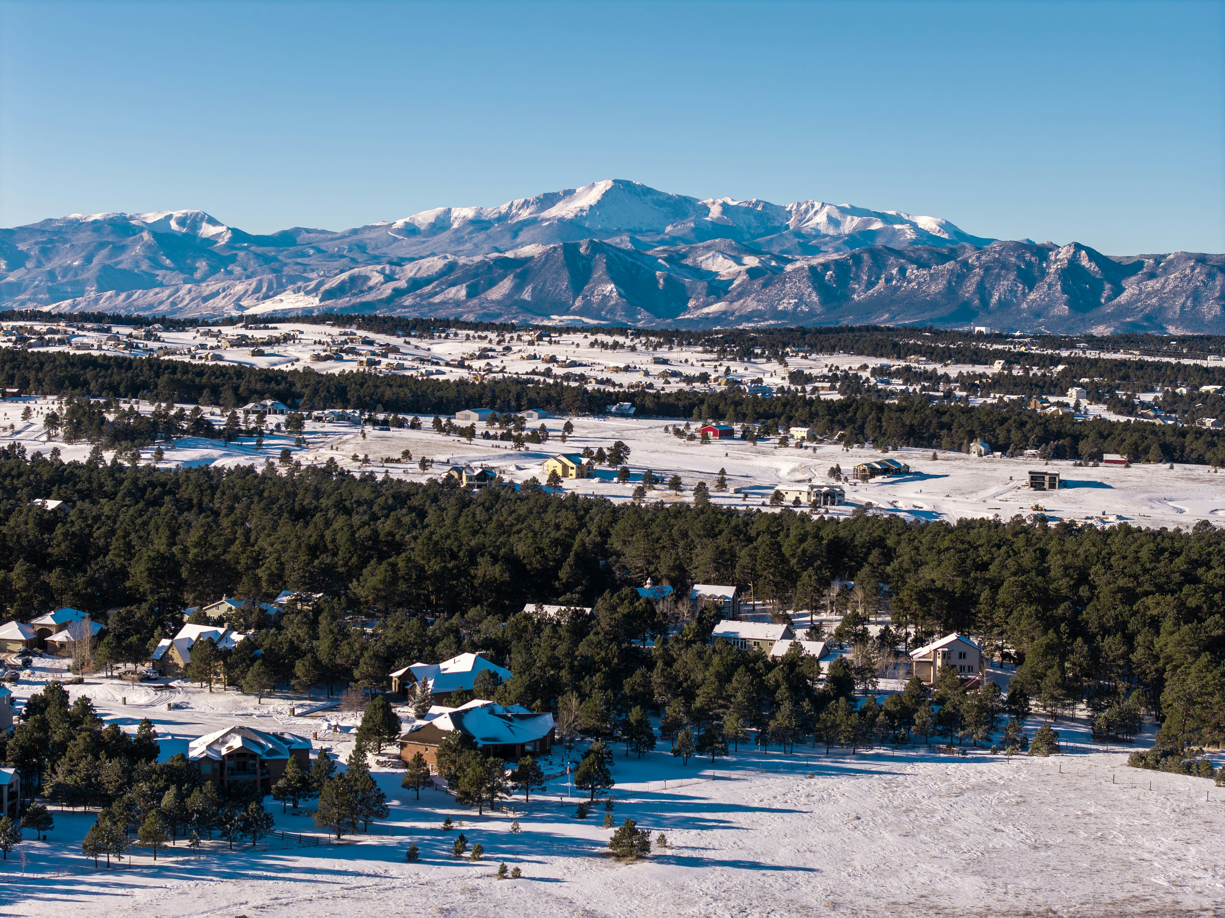 An aerial view of a small town surrounded by mountains