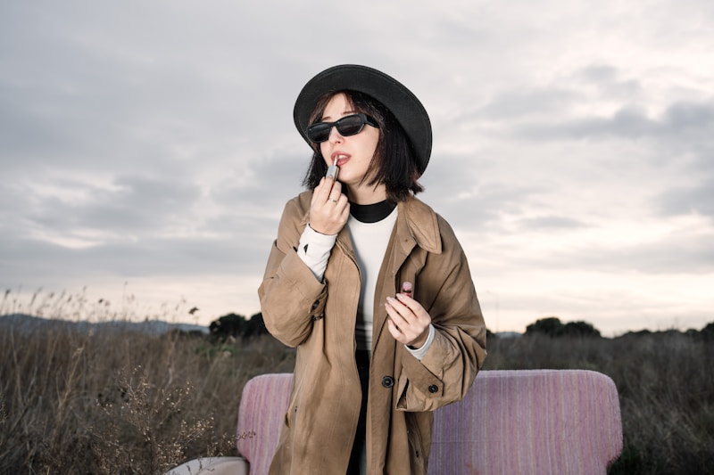 A woman standing in a field with a suitcase