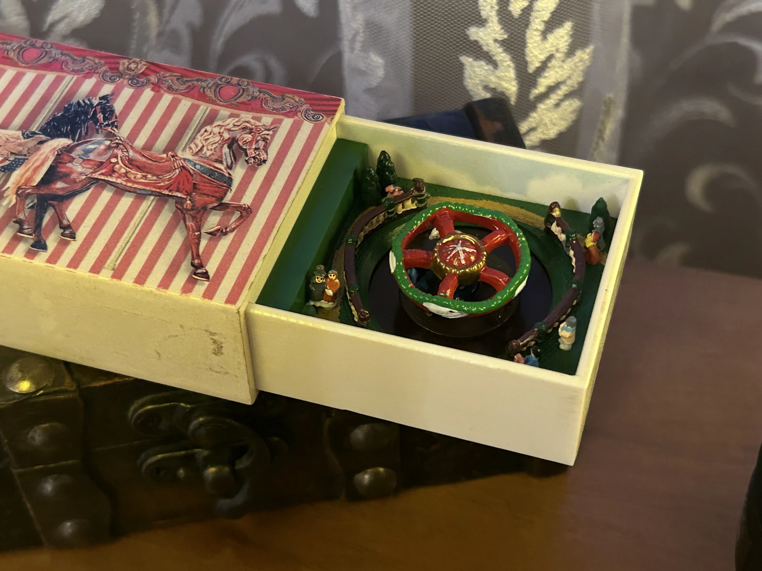 Matchbox Carousel: a tiny carousel movement in a slide-out drawer with a horse-print sleeve