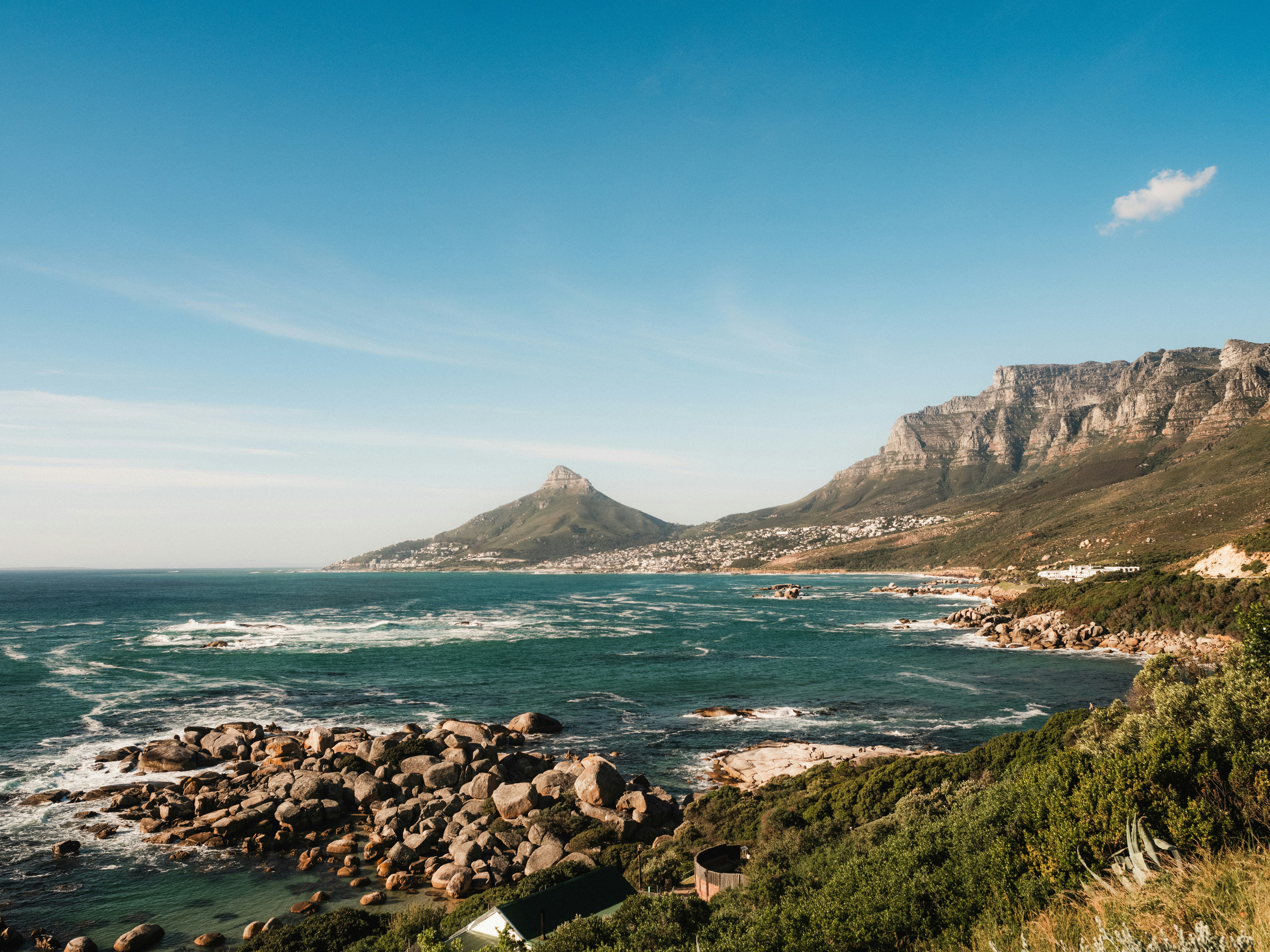 A scenic view of the ocean with mountains in the background