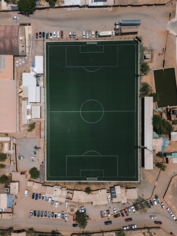 An aerial view of a soccer field and parking lot