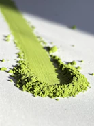 A close up of a green substance on a white surface