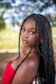 A woman with long dreadlocks posing for a picture