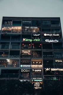 A tall building with a lot of signs on it