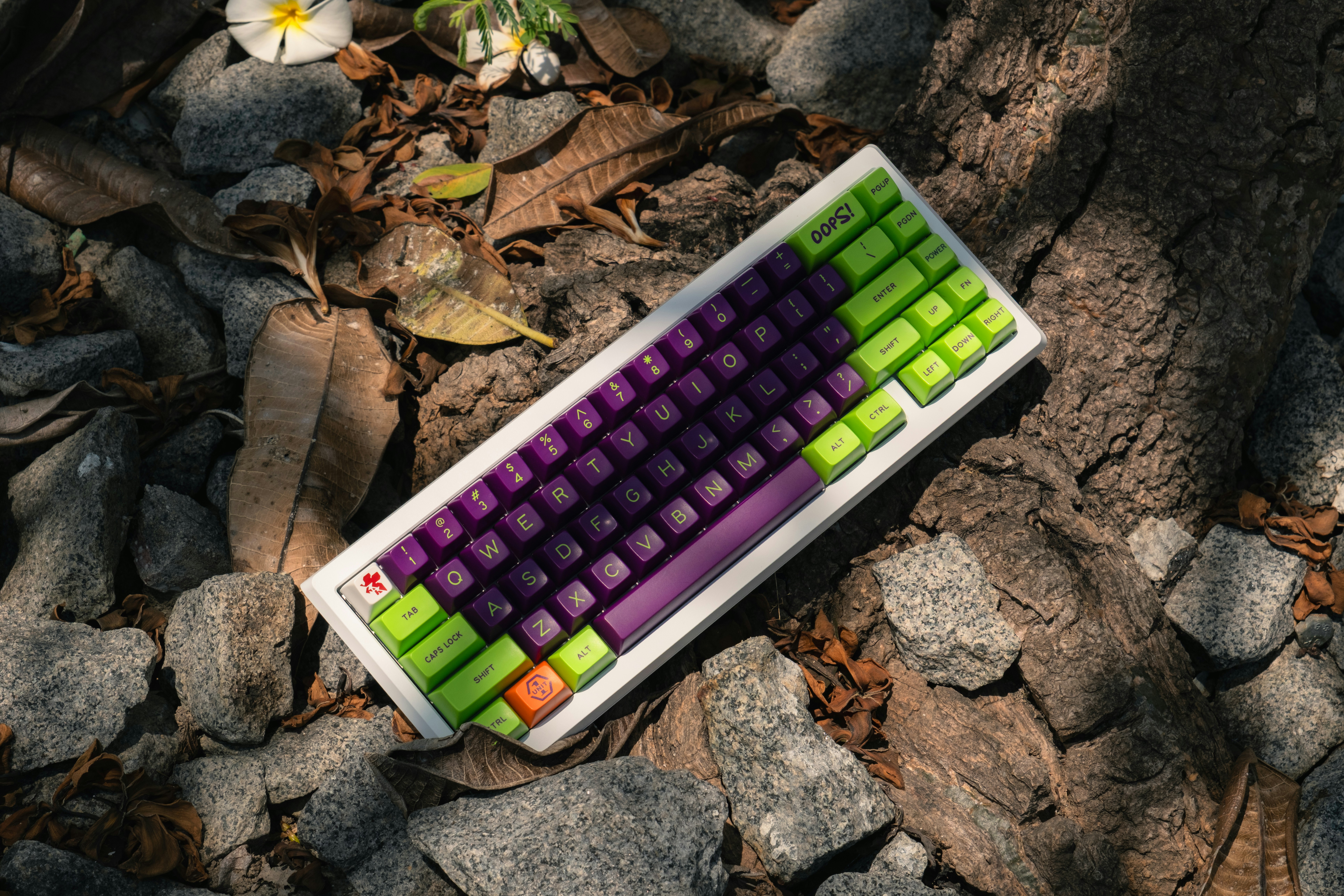 A computer keyboard laying on a bed of rocks