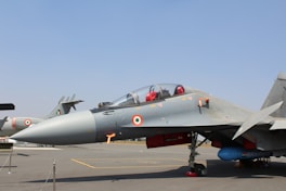 A fighter jet sitting on top of an airport tarmac