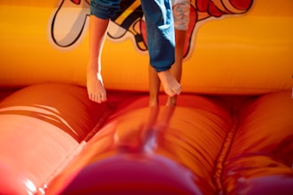 A young boy jumping on a bouncy castle