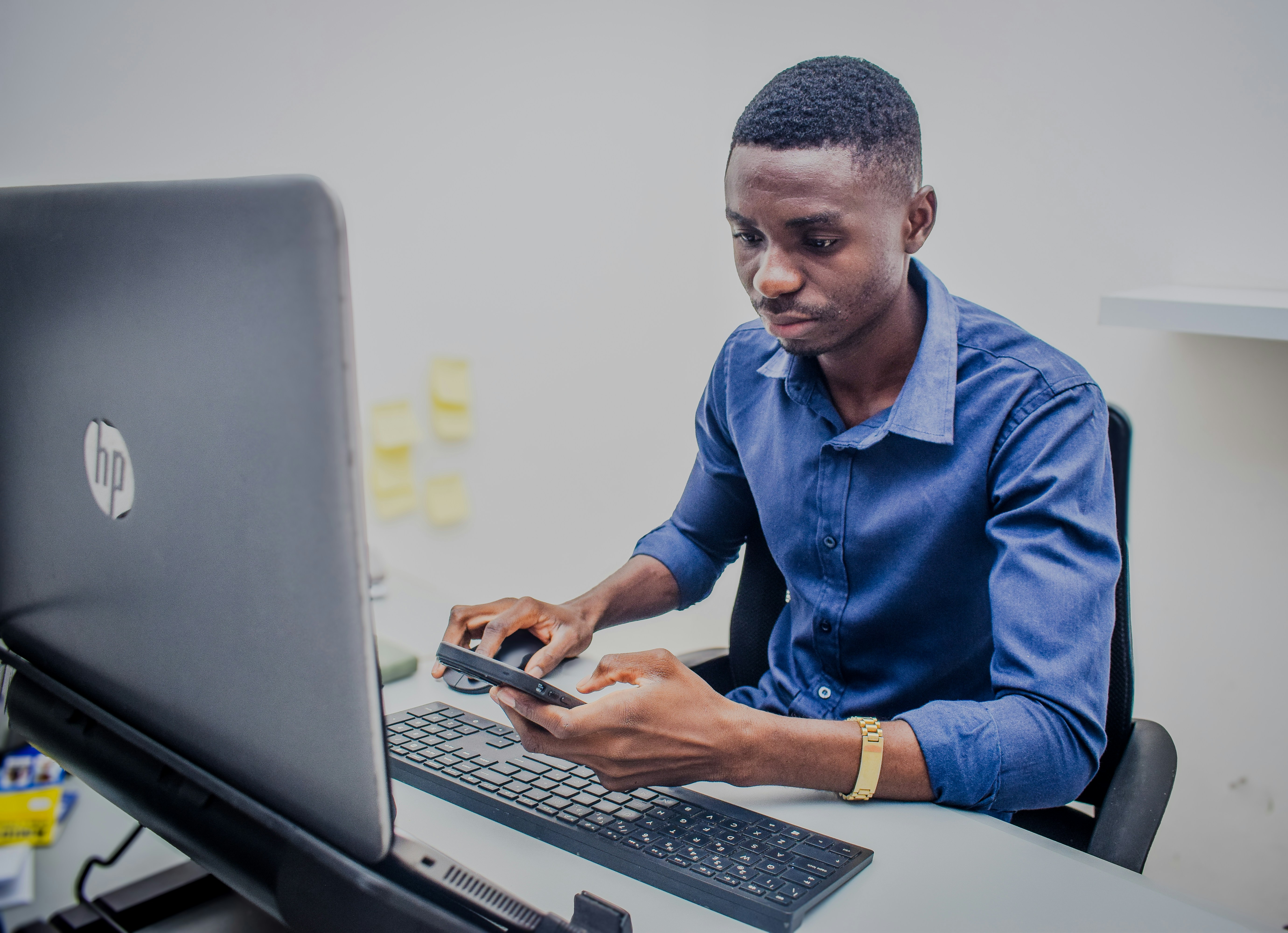 A man sitting in front of a laptop computer