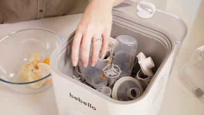 A person putting their hand in a blender