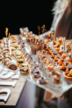 A table topped with lots of food on top of a wooden table
