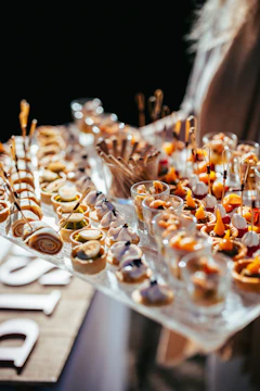 A table topped with lots of food on top of a wooden table