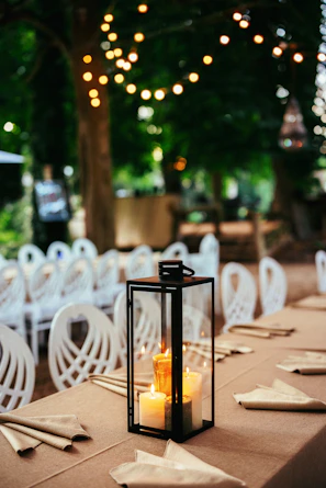 A lantern is lit up on a long table