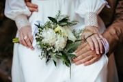 A close up of a person holding a bouquet of flowers