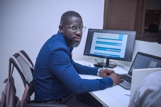 A man sitting at a desk using a computer