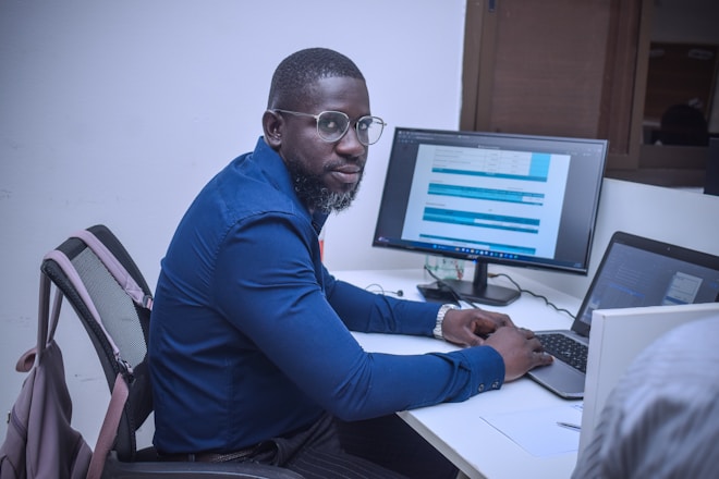 A man sitting at a desk using a computer