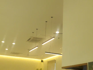 A room that has some lights on the ceiling