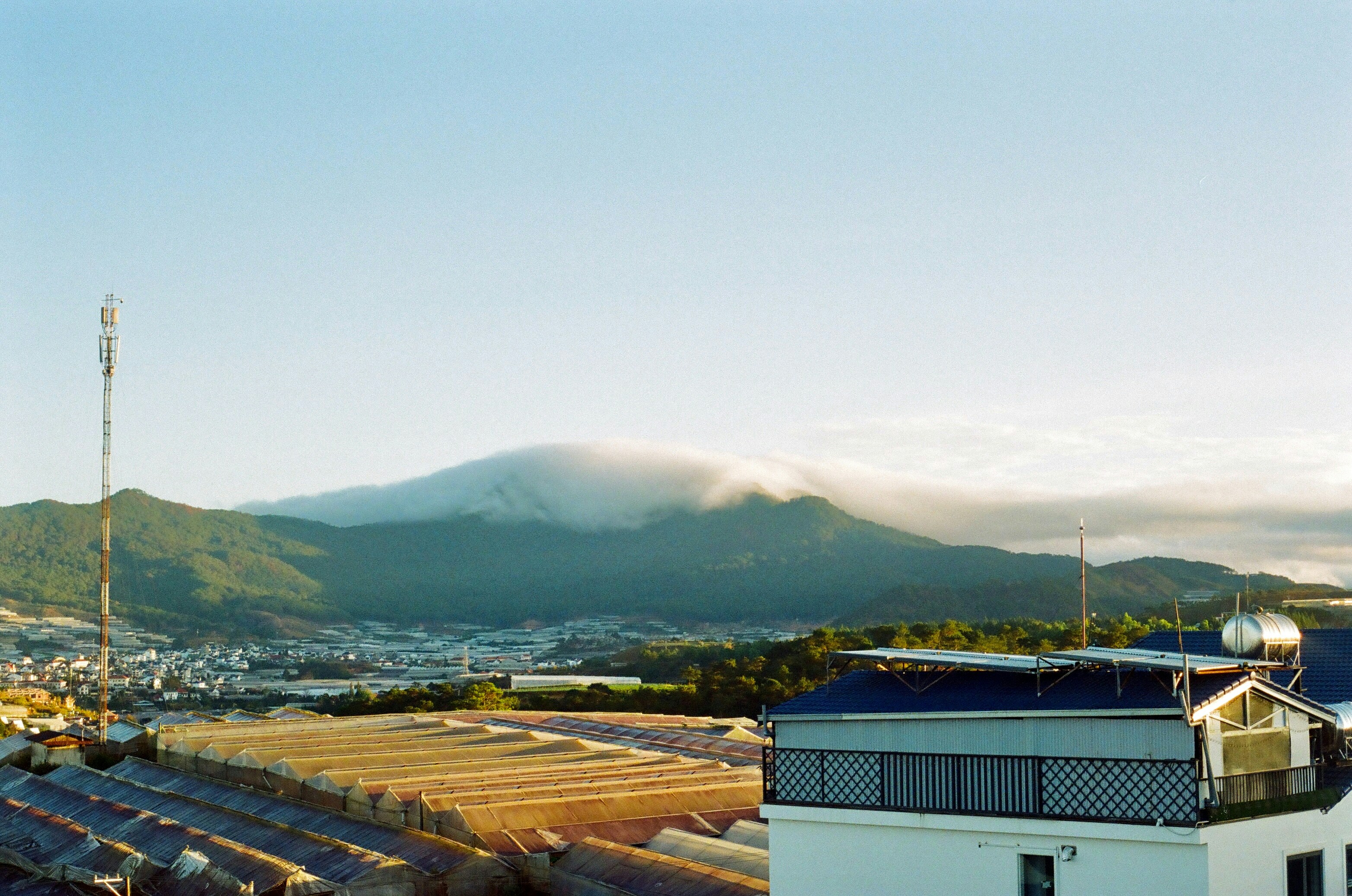 A view of a building with a mountain in the background